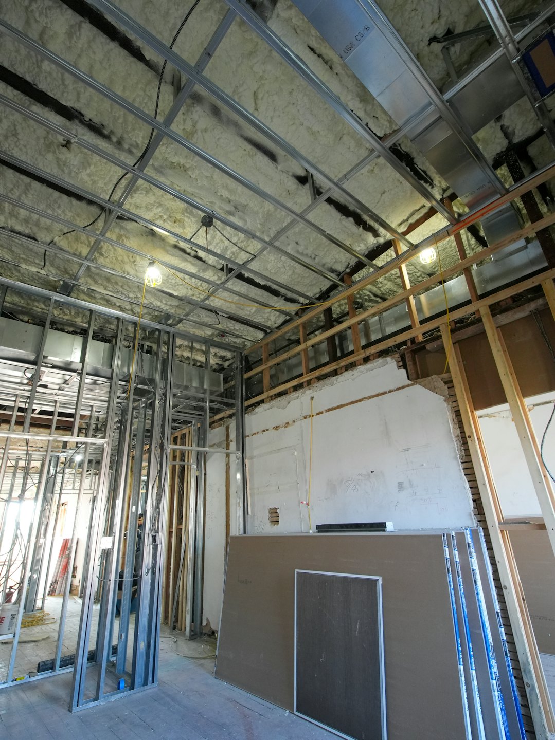 Commercial building interior showing framing and insulation during renovation.